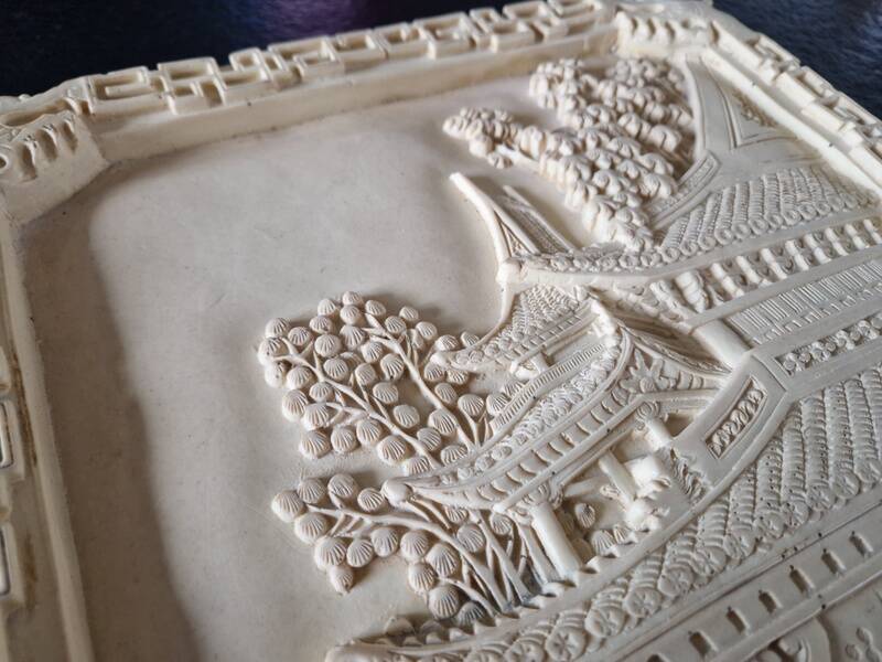 Sculpted resin plaque in the style of China.
