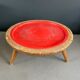 Wooden and red plastic compasses plant stand.