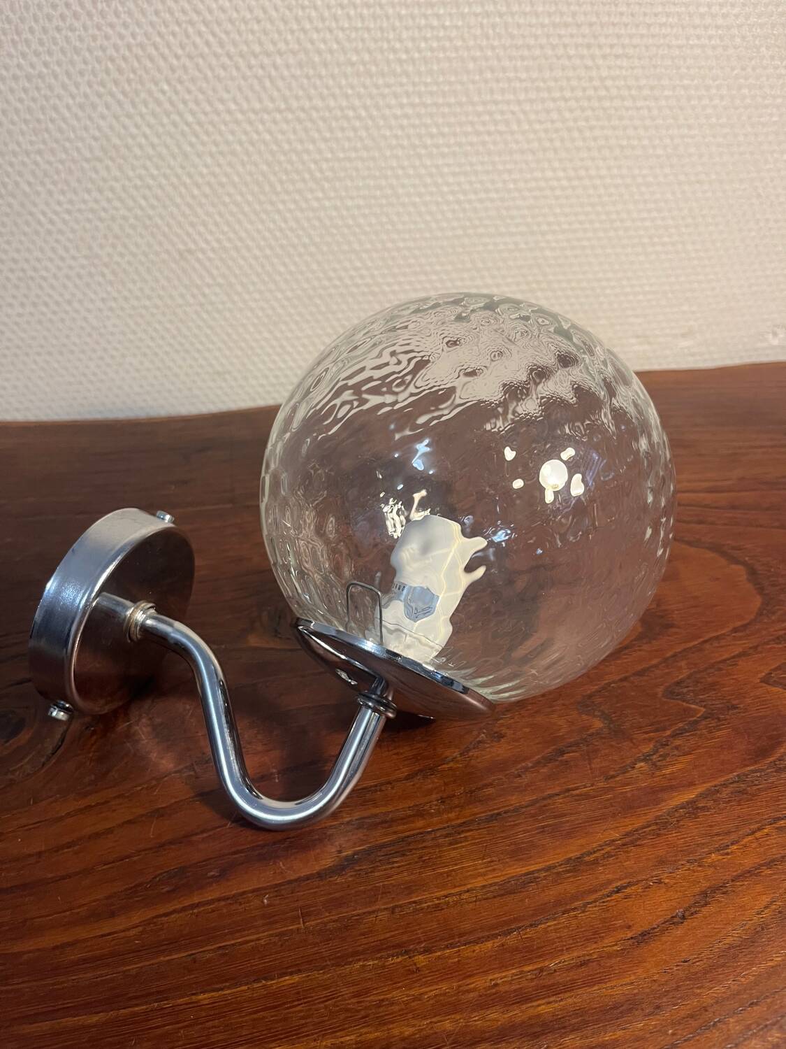 Delmas chrome wall light with chiseled glass globe