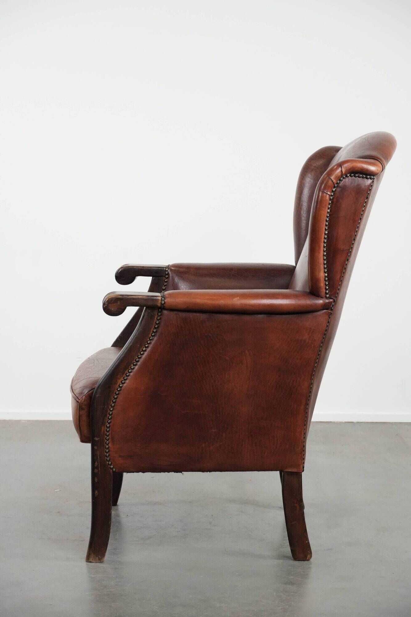 Classic vintage wingback chair in sheepskin and wood