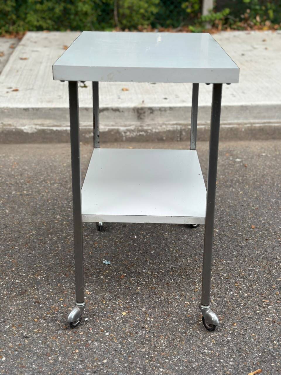 Rolling dessert trolley with 2 white formica shelves and steel, 1980.
