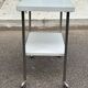 Rolling dessert trolley with 2 white formica shelves and steel, 1980.