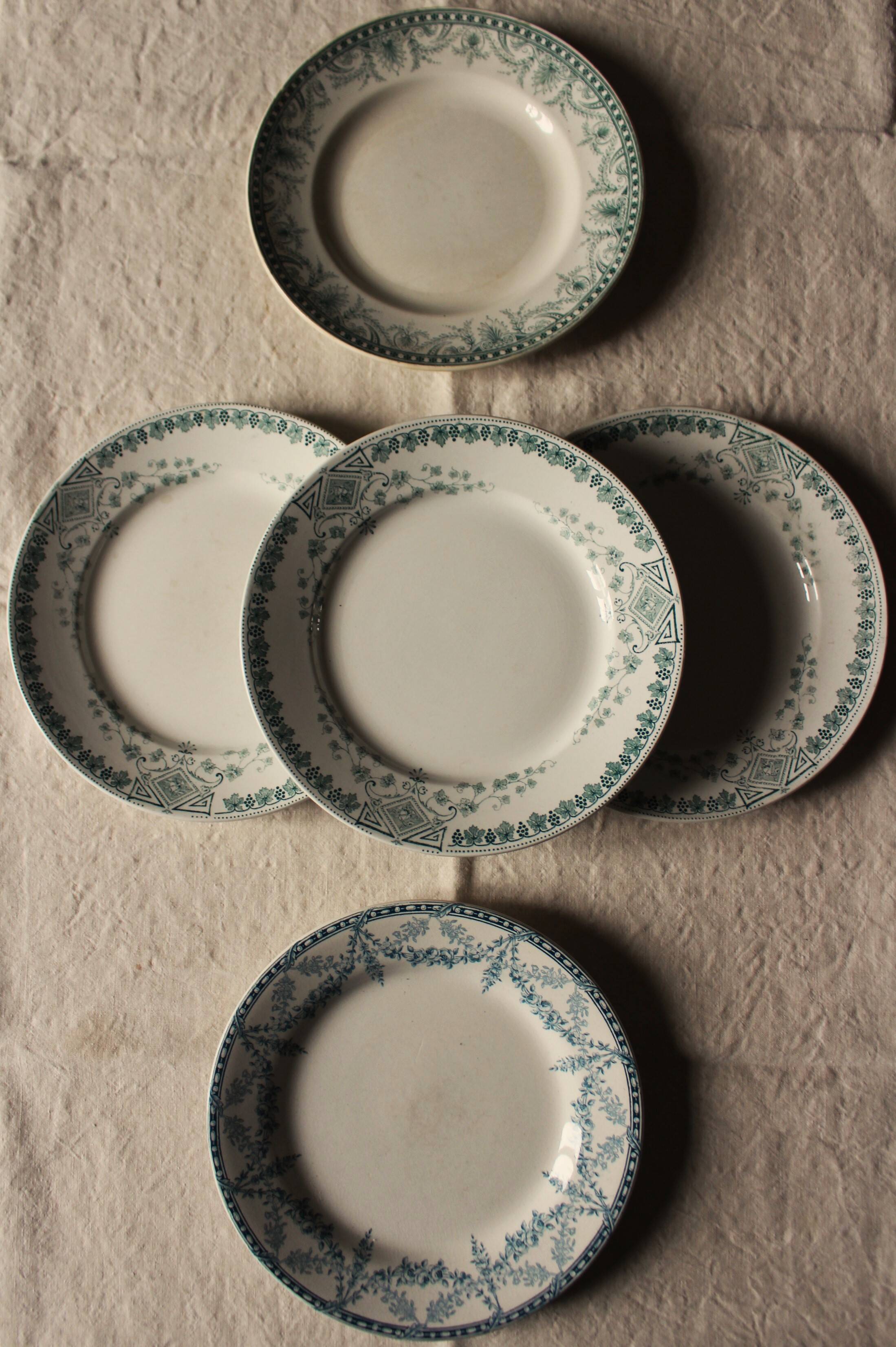 A set of 5 mismatched green blue Terre de fer flat plates