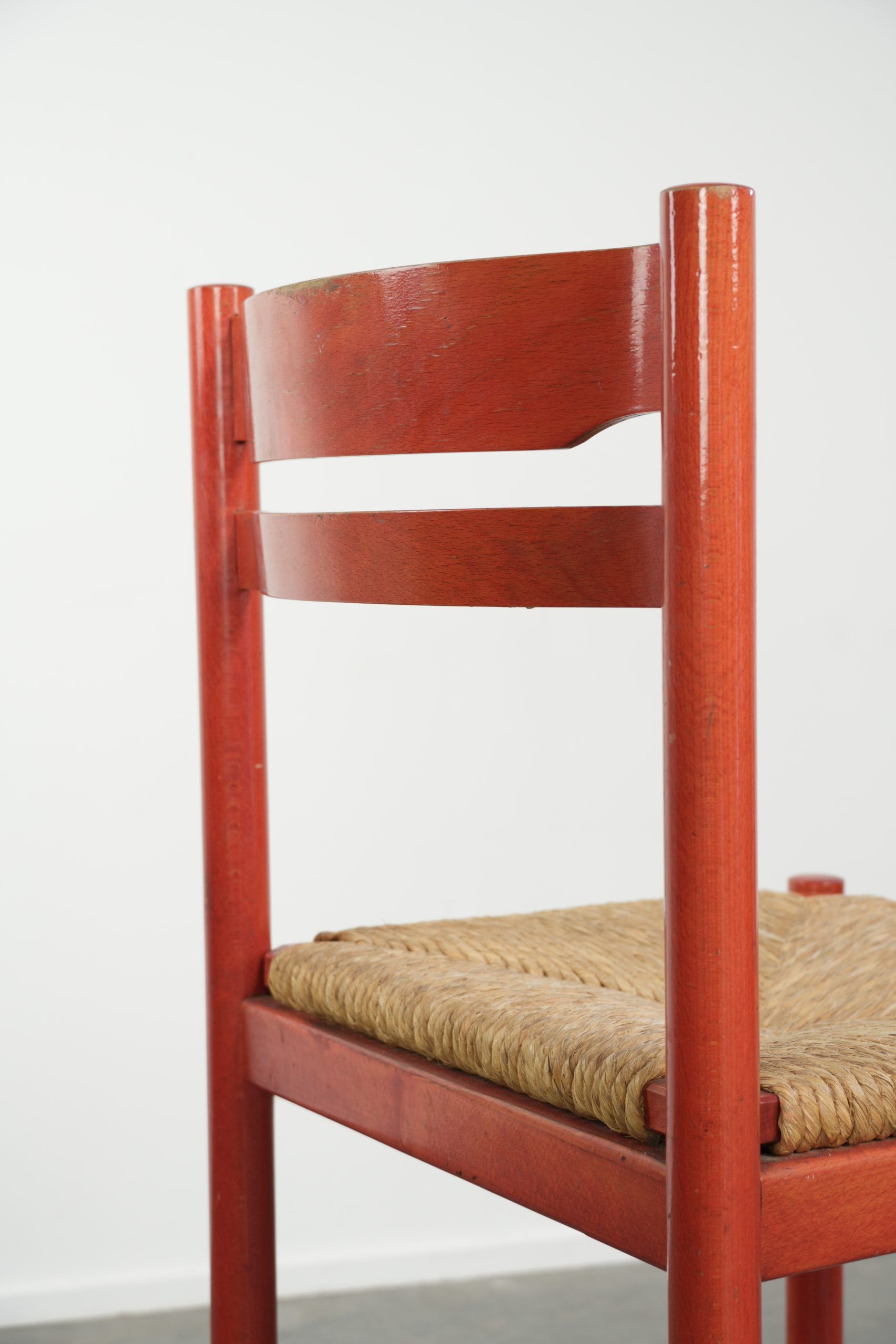 Nice red vintage wooden chair from the 1970s with a woven wicker seat