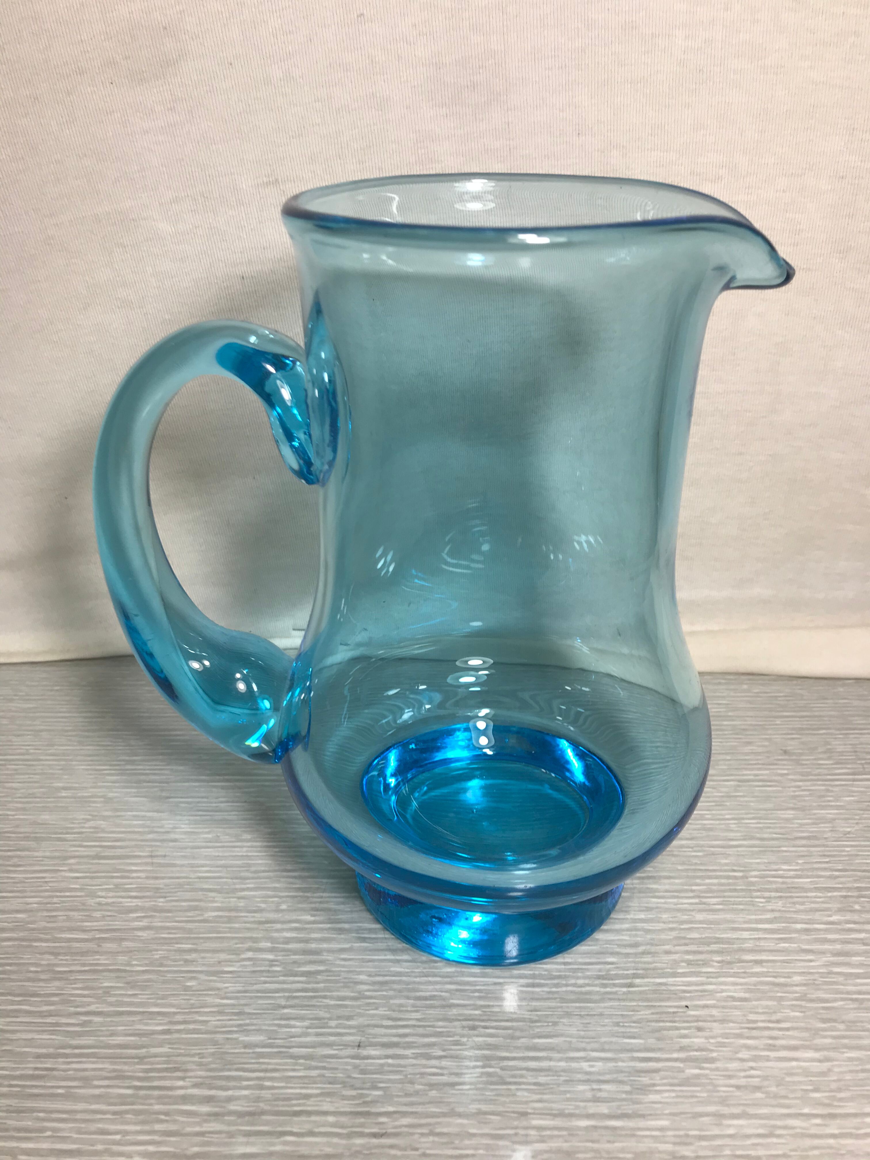 Old blue blown glass pitcher with vintage handle
