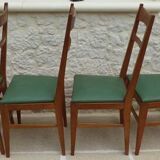 6 modern chairs with banded backs and green faux leather seats