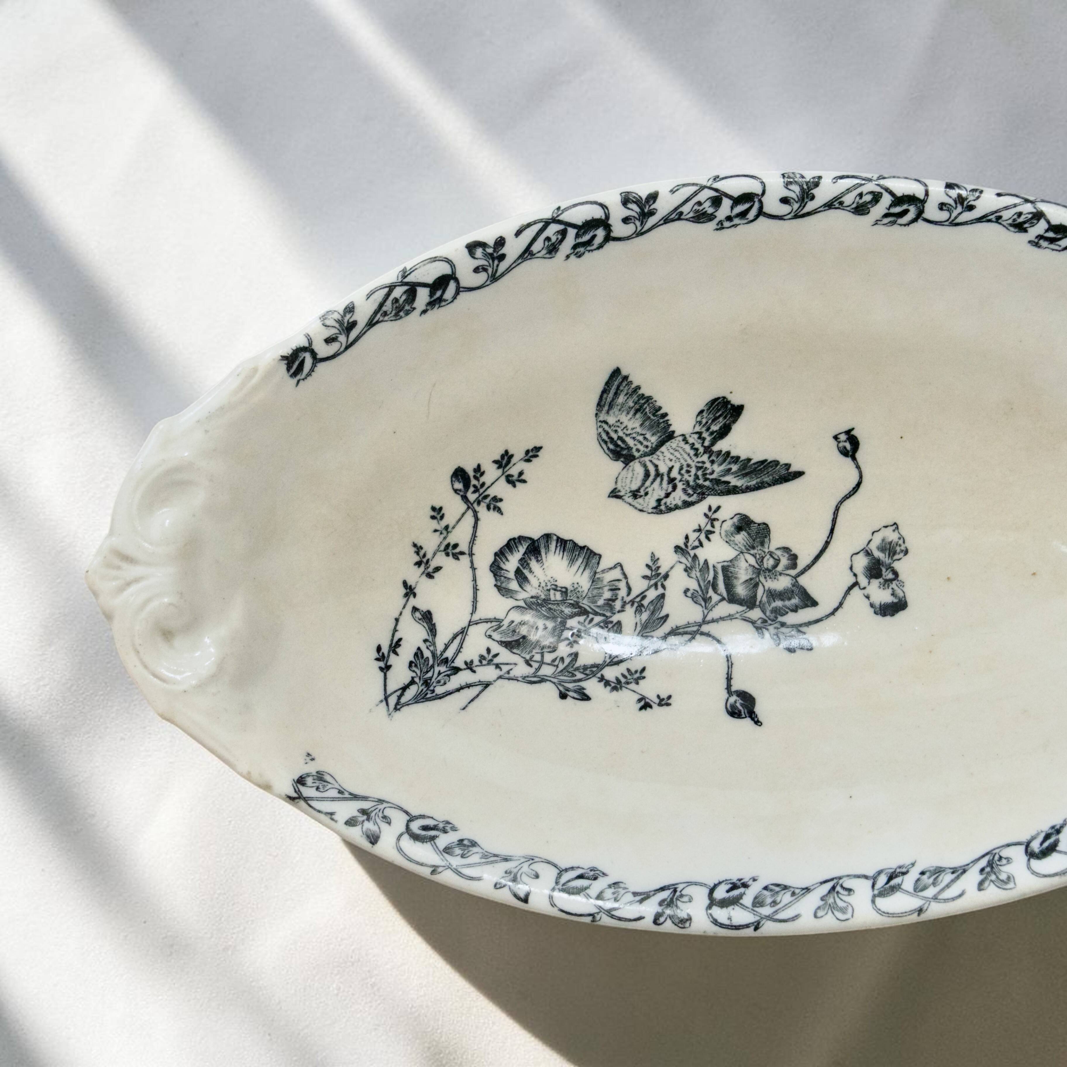 Iron flat plate with a 19th-century bird signed Onnaing "Poppies"