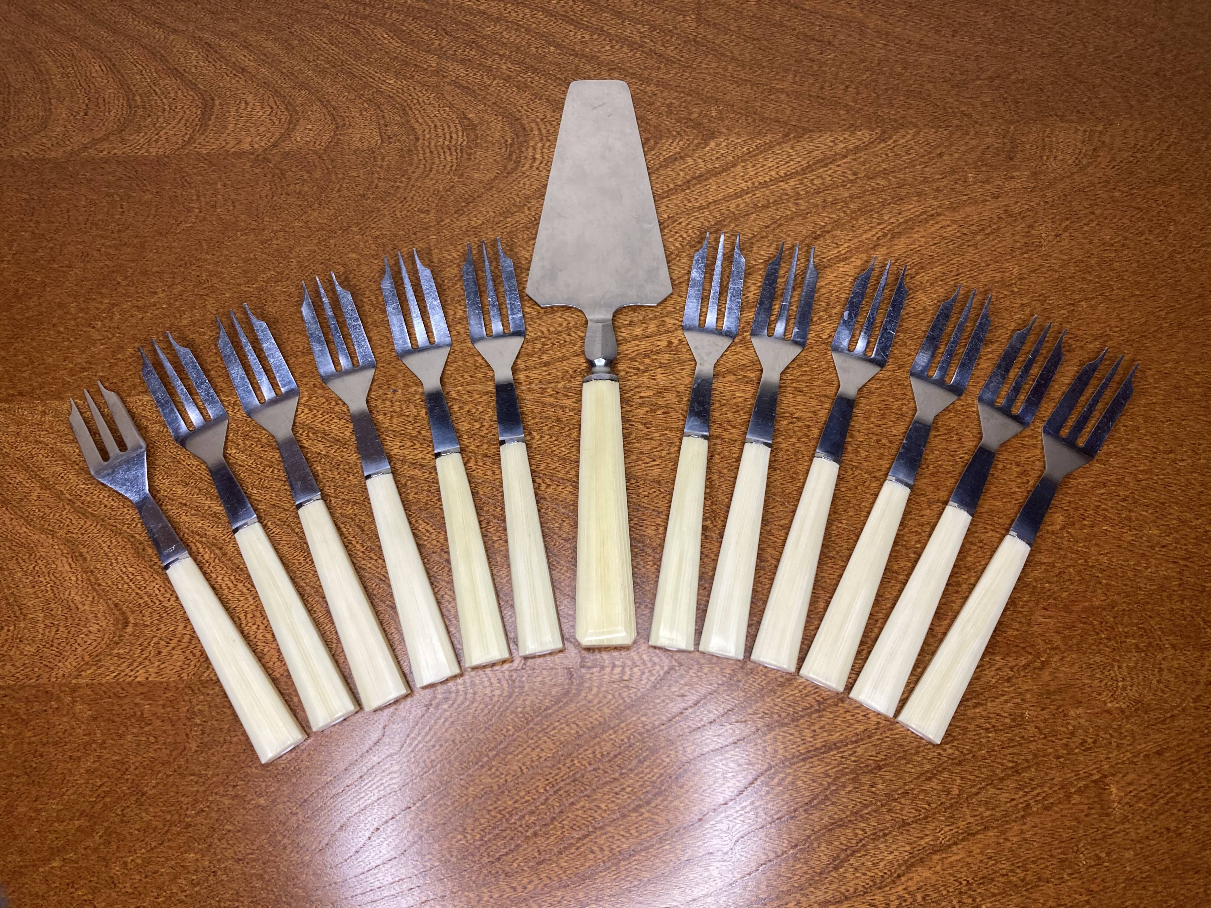 12 dessert forks and stainless steel pie shovel and ecru Bakelite handle