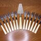 12 dessert forks and stainless steel pie shovel and ecru Bakelite handle