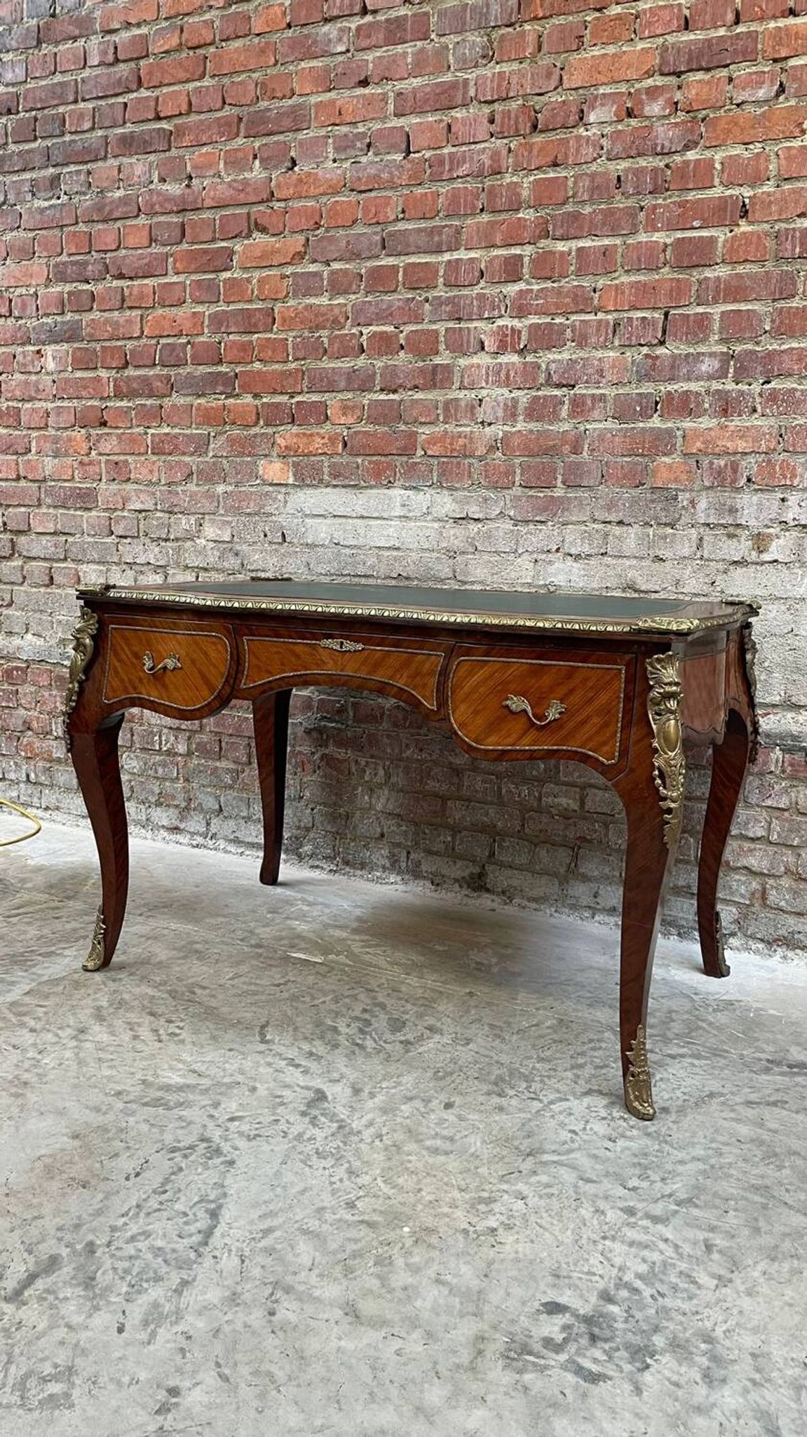 Antique French-style desk with green leather top and bronze mounts