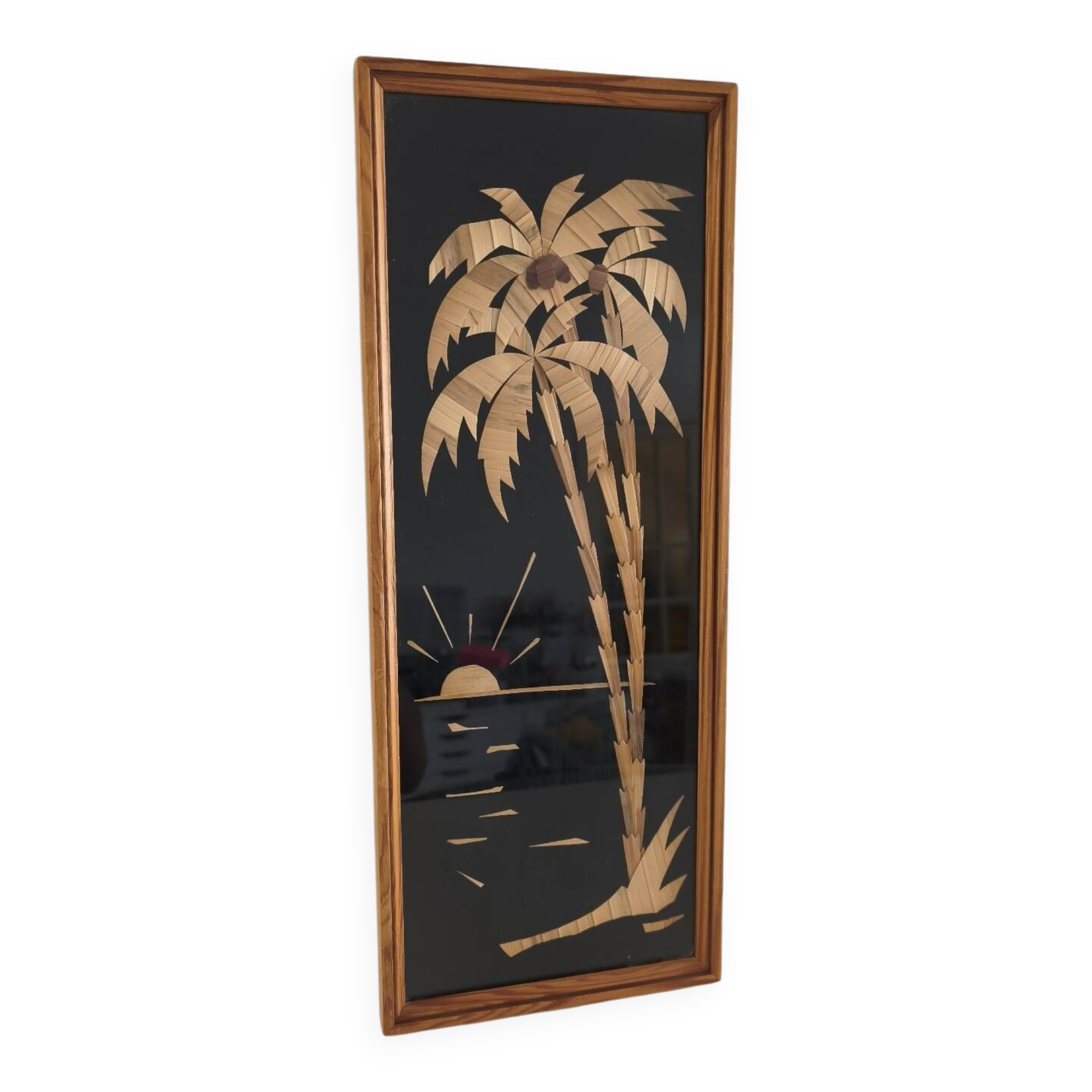 Vintage frame with palm tree and sun in wood or wicker.