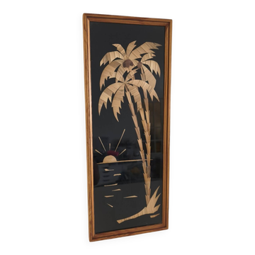 Vintage frame with palm tree and sun in wood or wicker.