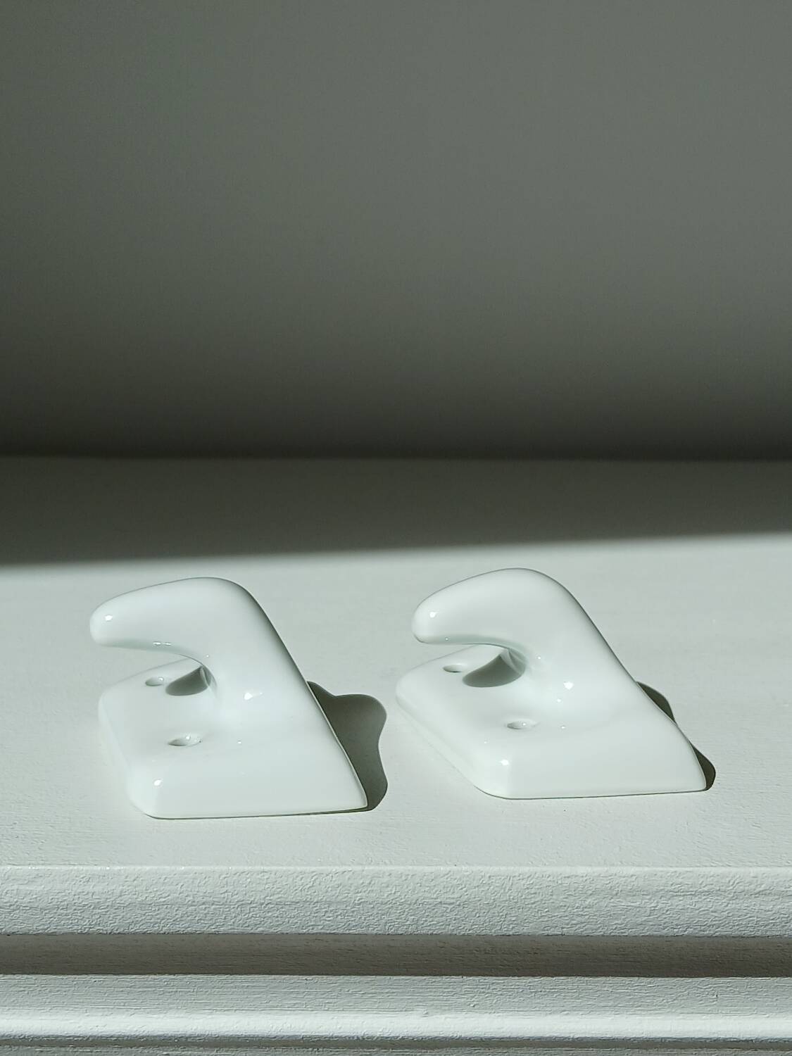 Set of two porcelain tea towel holders