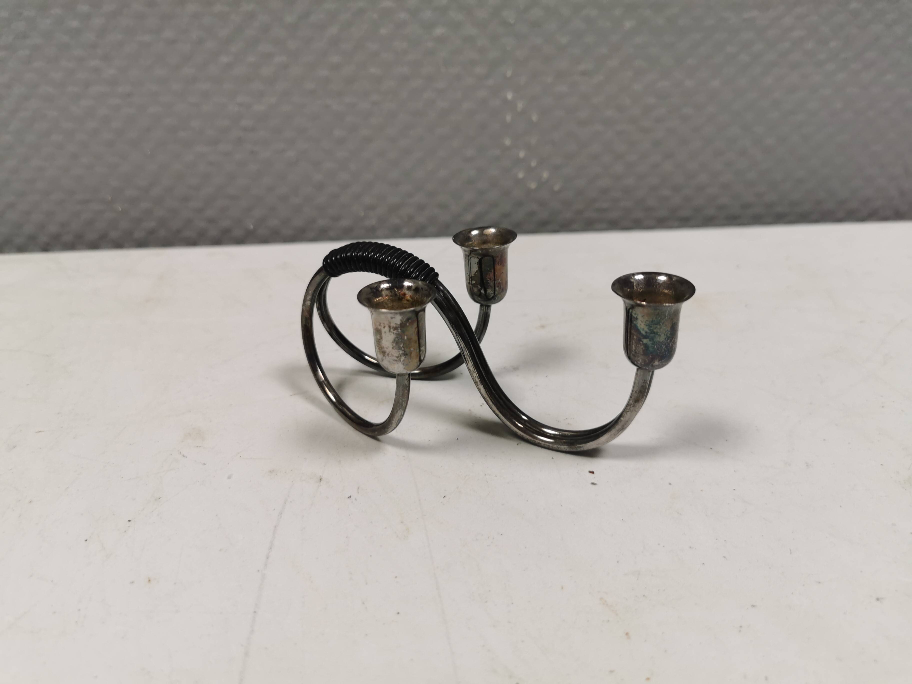 Small candle holder in tarnished silver, with place for three small candles