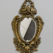 Mirror in the Louis XV Rocaille style in gilded bronze.