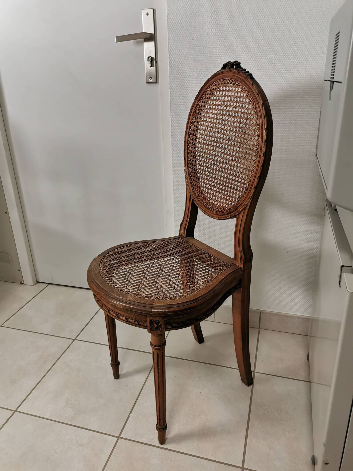 Antique chair Louis XVI style, seat caned, carved wood