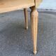 Extendable round table in renovated Louis XVI style, made of light wood, with 2 extensions.