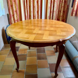 Round extendable wooden table with glass top