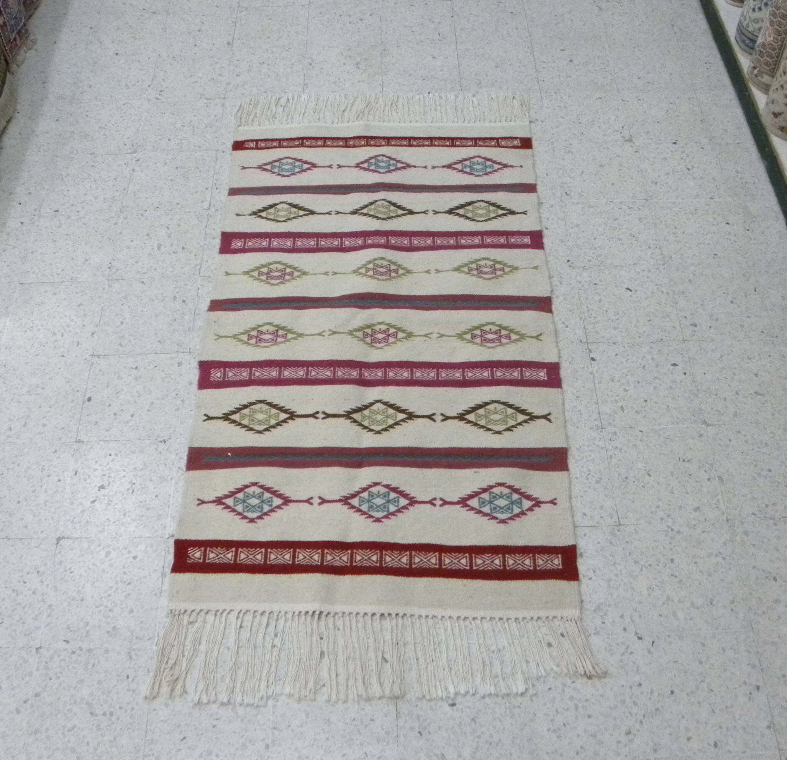 Tribal bohemian kilim rug with geometric pattern in wool.
