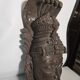 Ancient Indian carved wooden mask sculpture of a deity with a cobra.