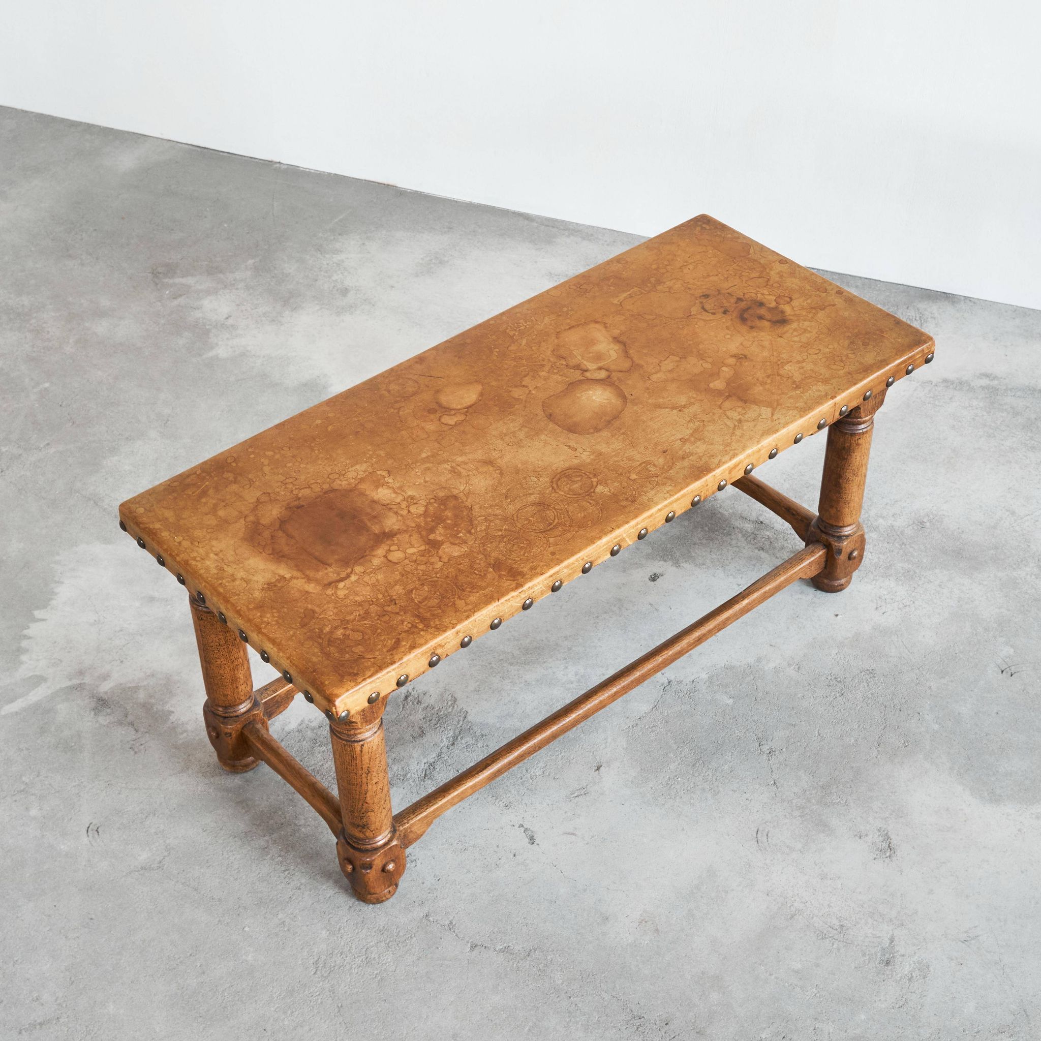 Brutalist coffee table in solid oak, metal, and patinated leather, 1940s.