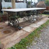 Marble table with wrought iron legs.
