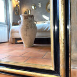 Louis-Philippe mirror in black and silver, 19th century.