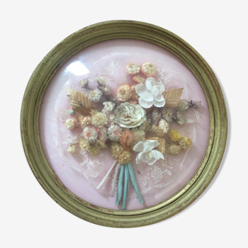 Vintage round domed frame with dried flowers.