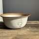 Small thick stoneware bowl with a stylised flower pattern in white on the outside, b