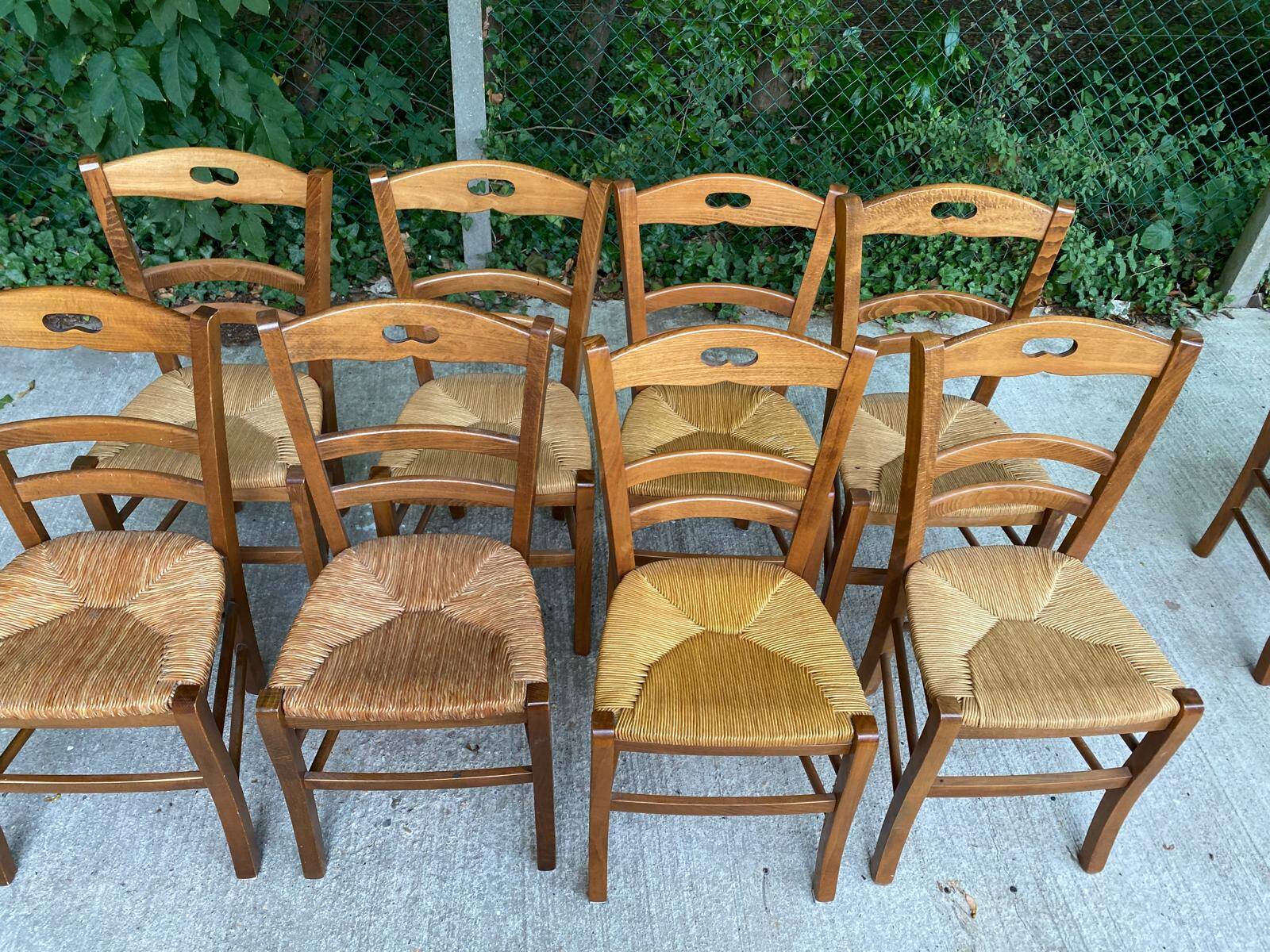 12 solid wood and straw chairs