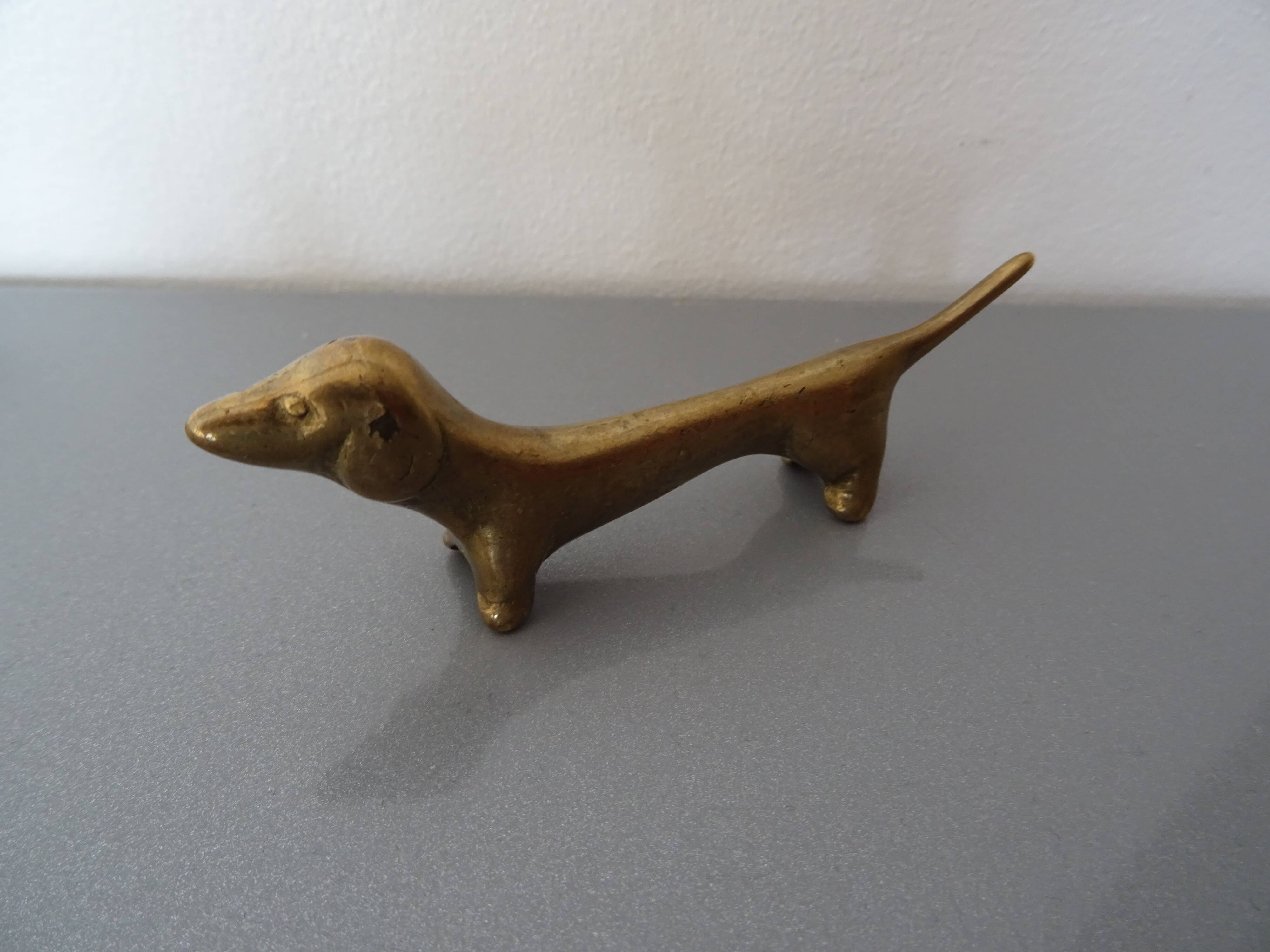 Series of 6 vintage gilded brass dachshund knife holders