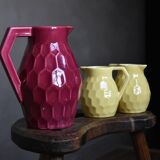 Raspberry carafe and two yellow pitchers