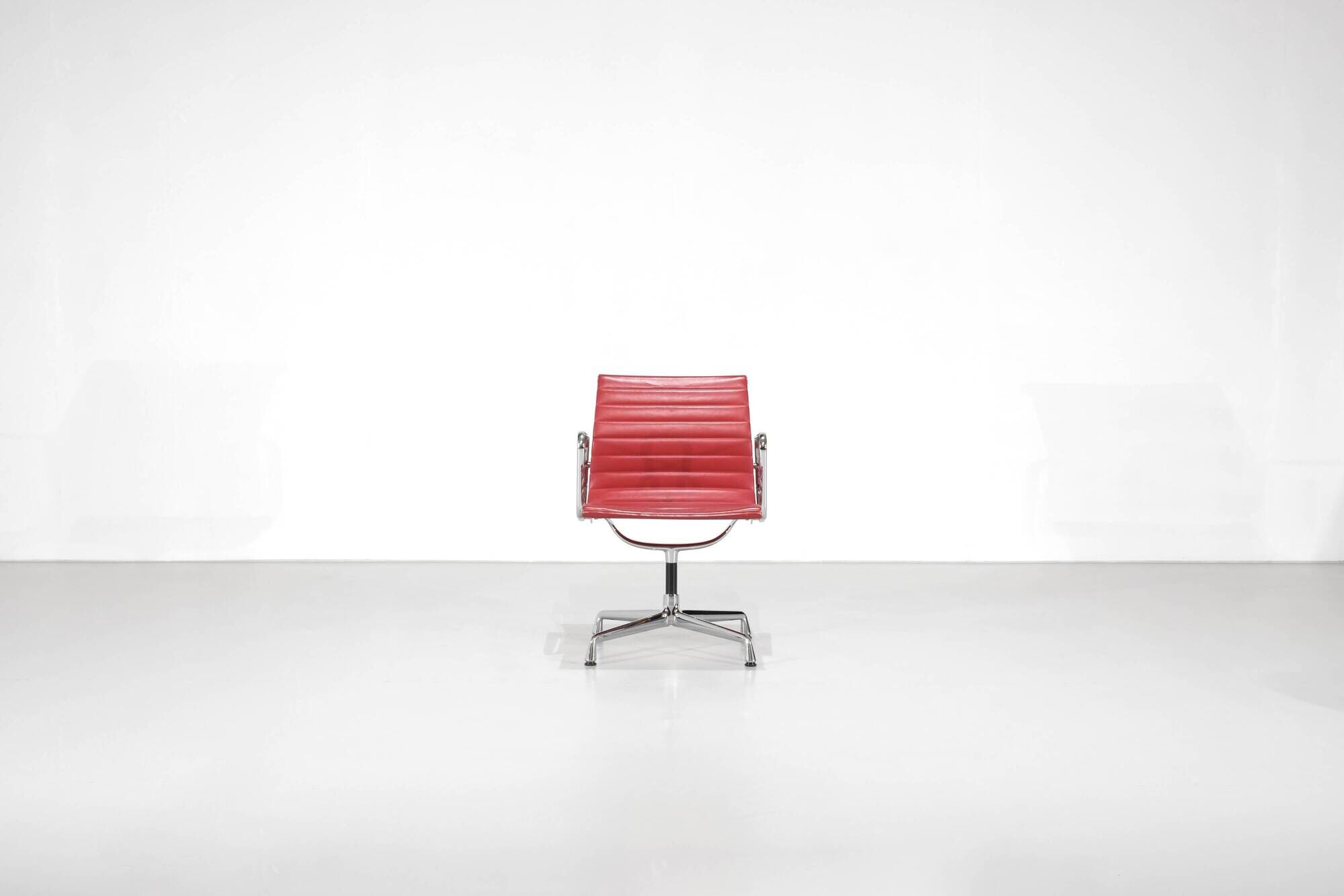 "EA 108" armchair in red leather, designed by Charles and Ray Eames for Vitra,