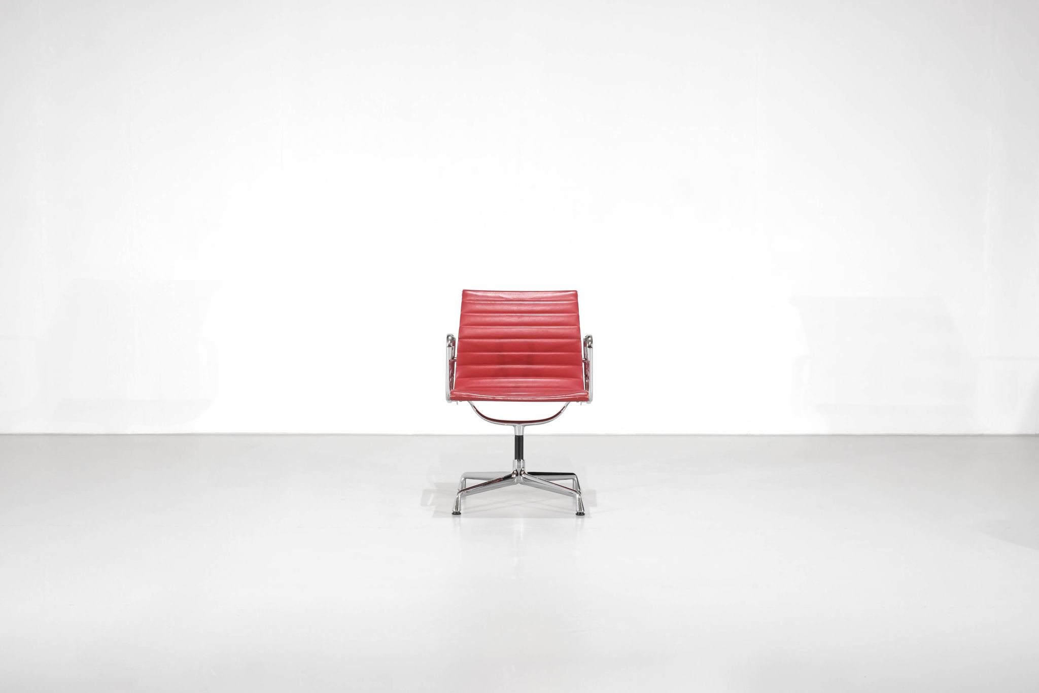 Fauteuil " EA 108 " en cuir rouge, conçu par Charles Ray Eames pour Vitra,