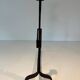 Pair of wrought iron andirons with adjustable supports and tripod feet.