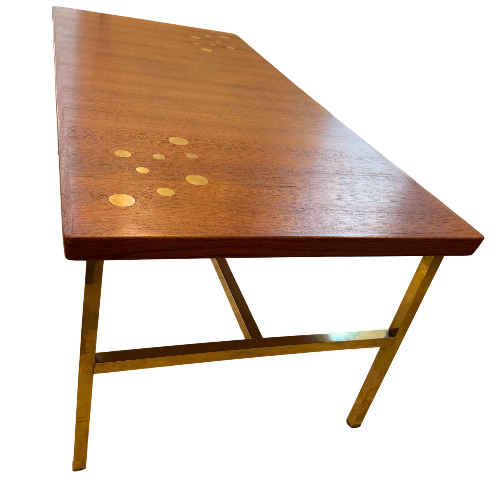 Scandinavian coffee table in teak and brass.