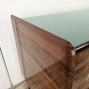 1950s mahogany sideboard with a glass top and central bar.
