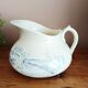 Old bulbous jug in ironstone earthenware