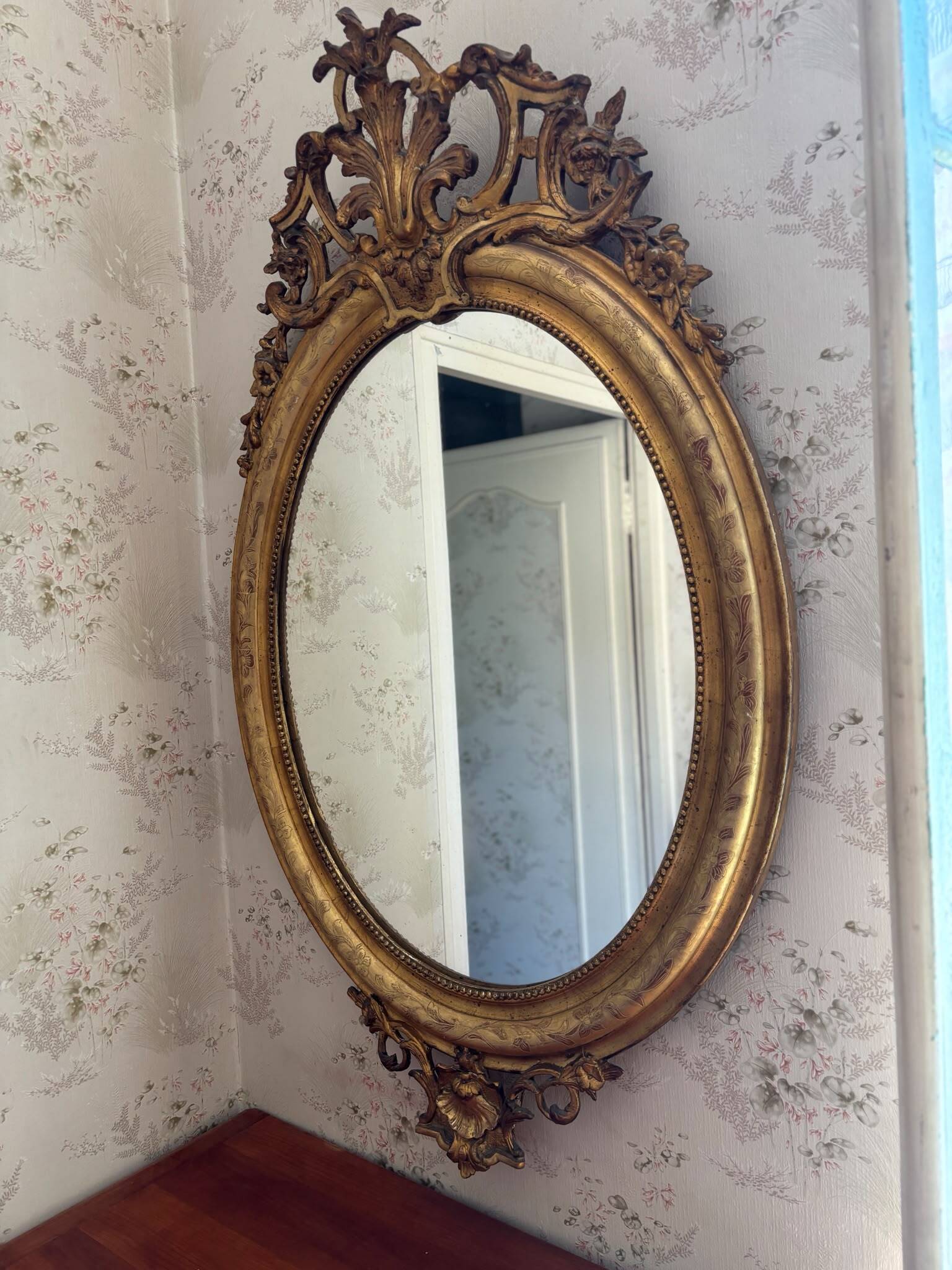 Golden oval mirror