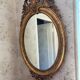 Golden oval mirror