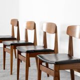 Ensemble de 4 chaises en teck et similicuir du milieu du siècle.