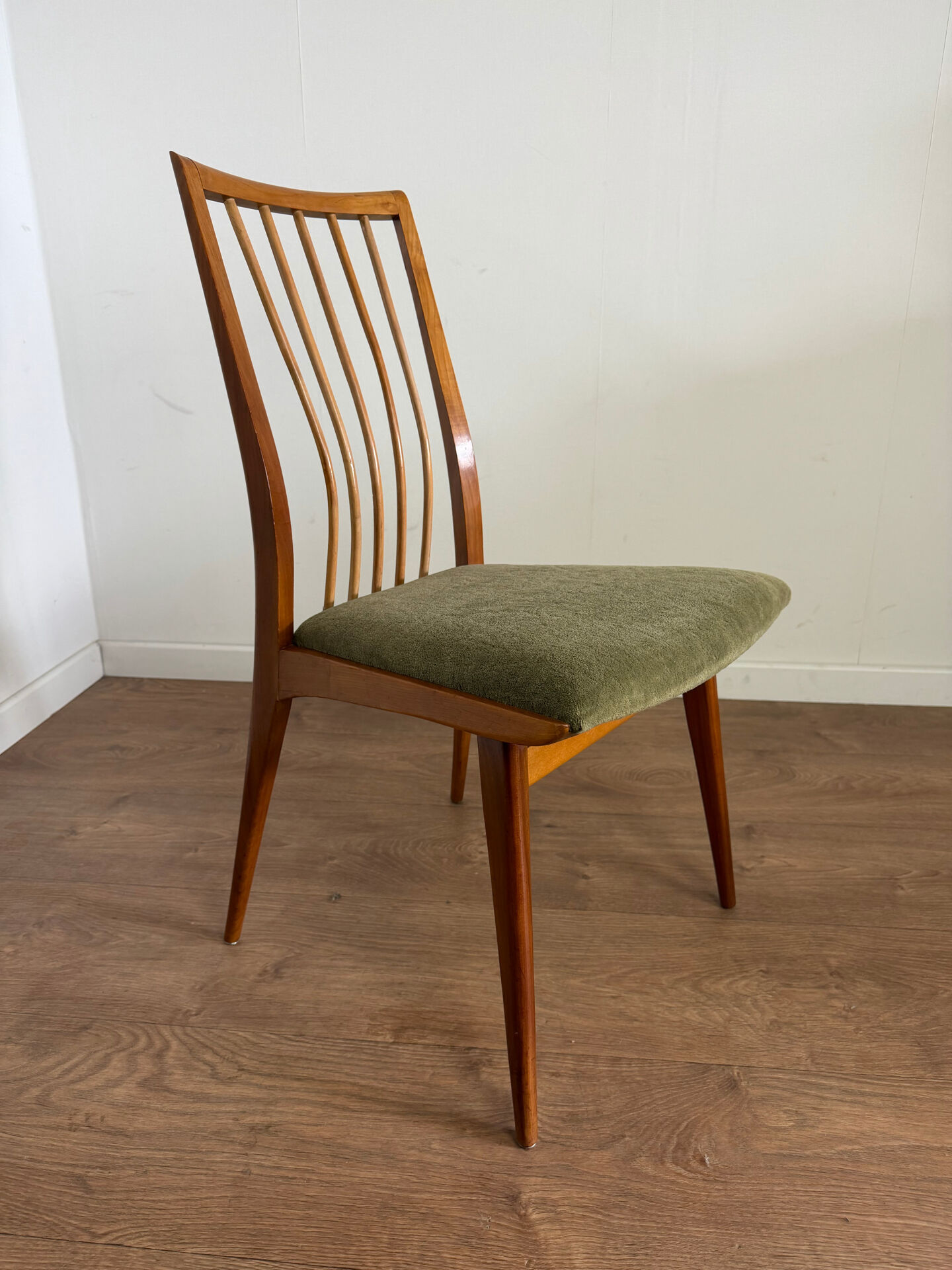 Scandinavian chairs with green velvet upholstery.