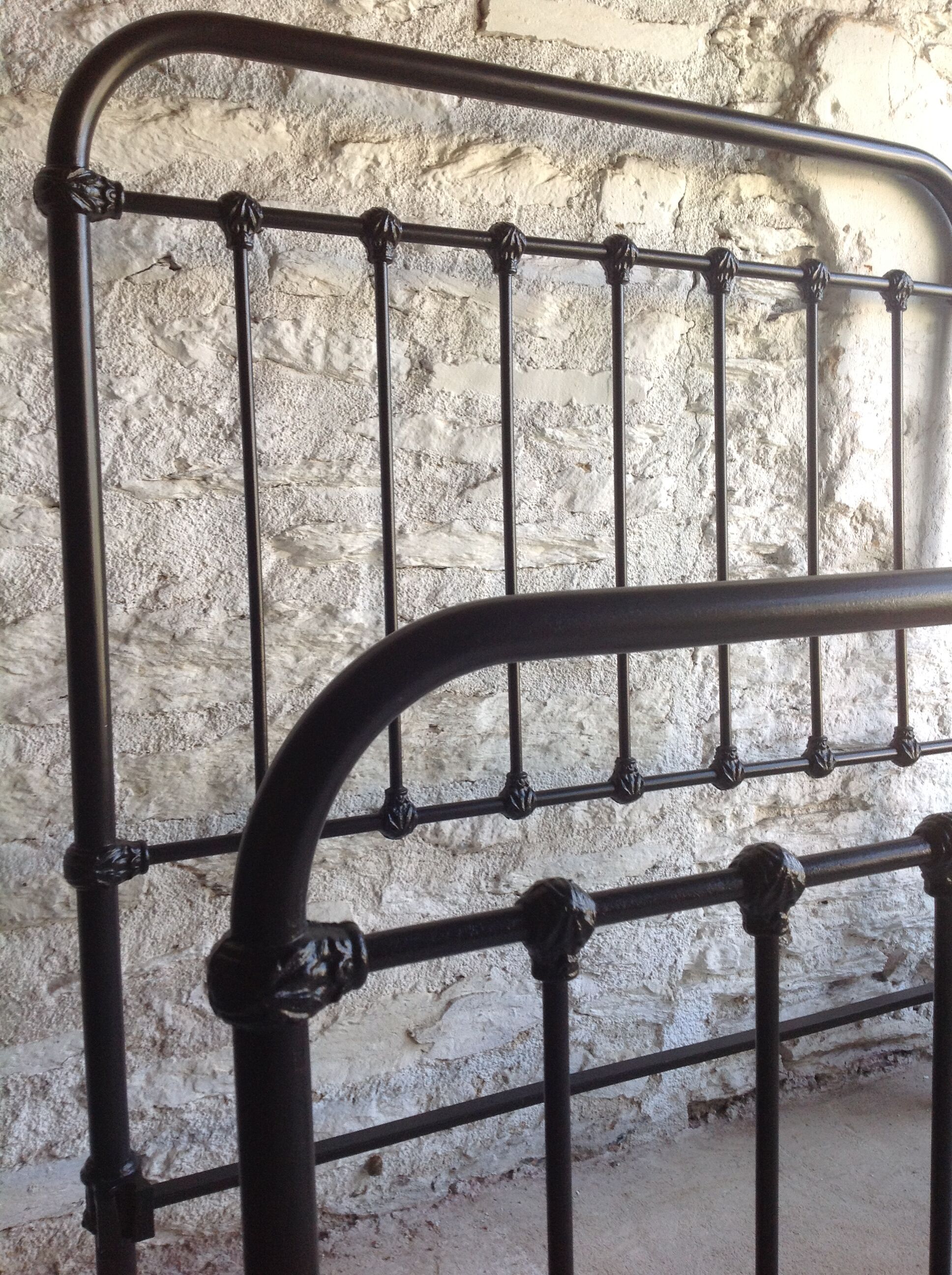 old bed with vintage painted metal bars