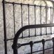 old bed with vintage painted metal bars