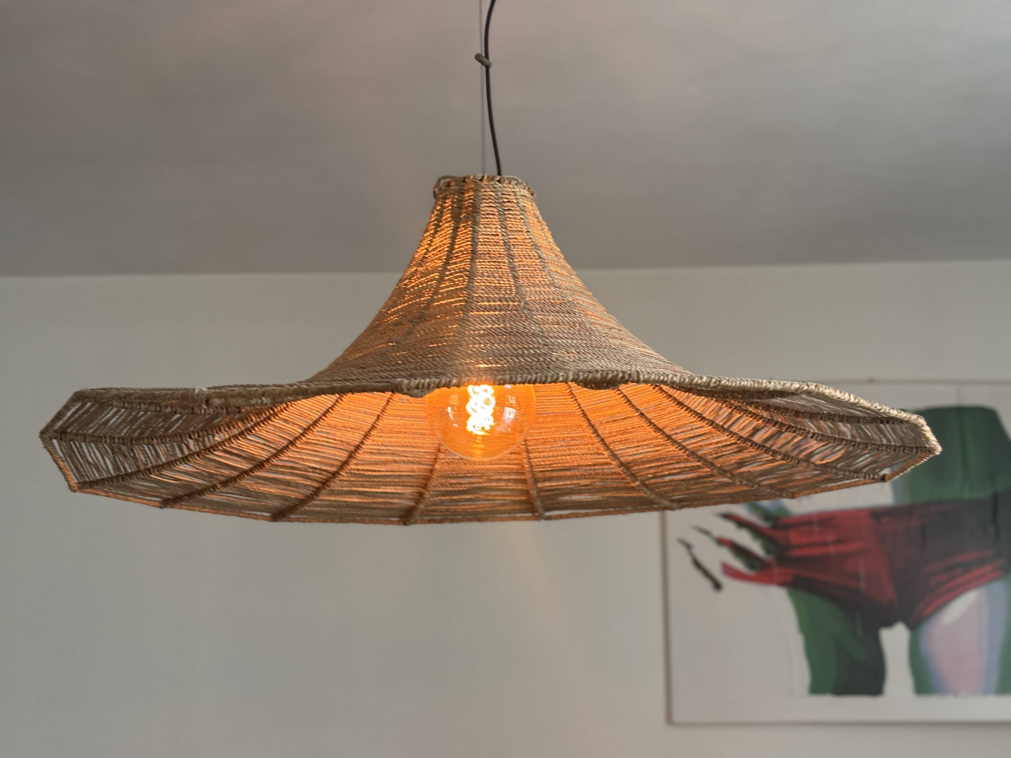 Large lampshade made of woven ropes.