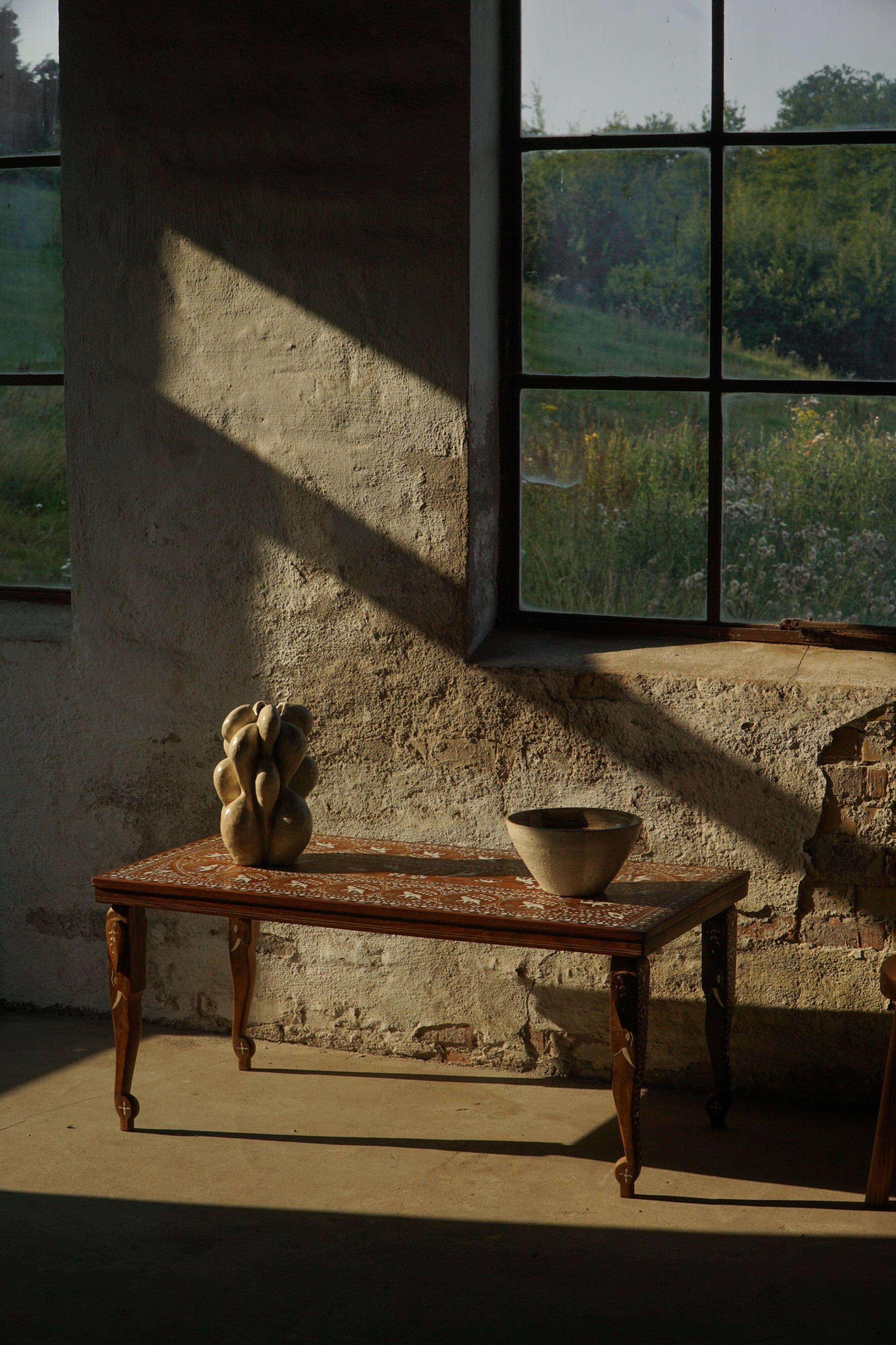 Vintage Indian teak coffee table inlaid with elephant motifs, mid-20th century.
