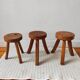 3 wooden tripod stools