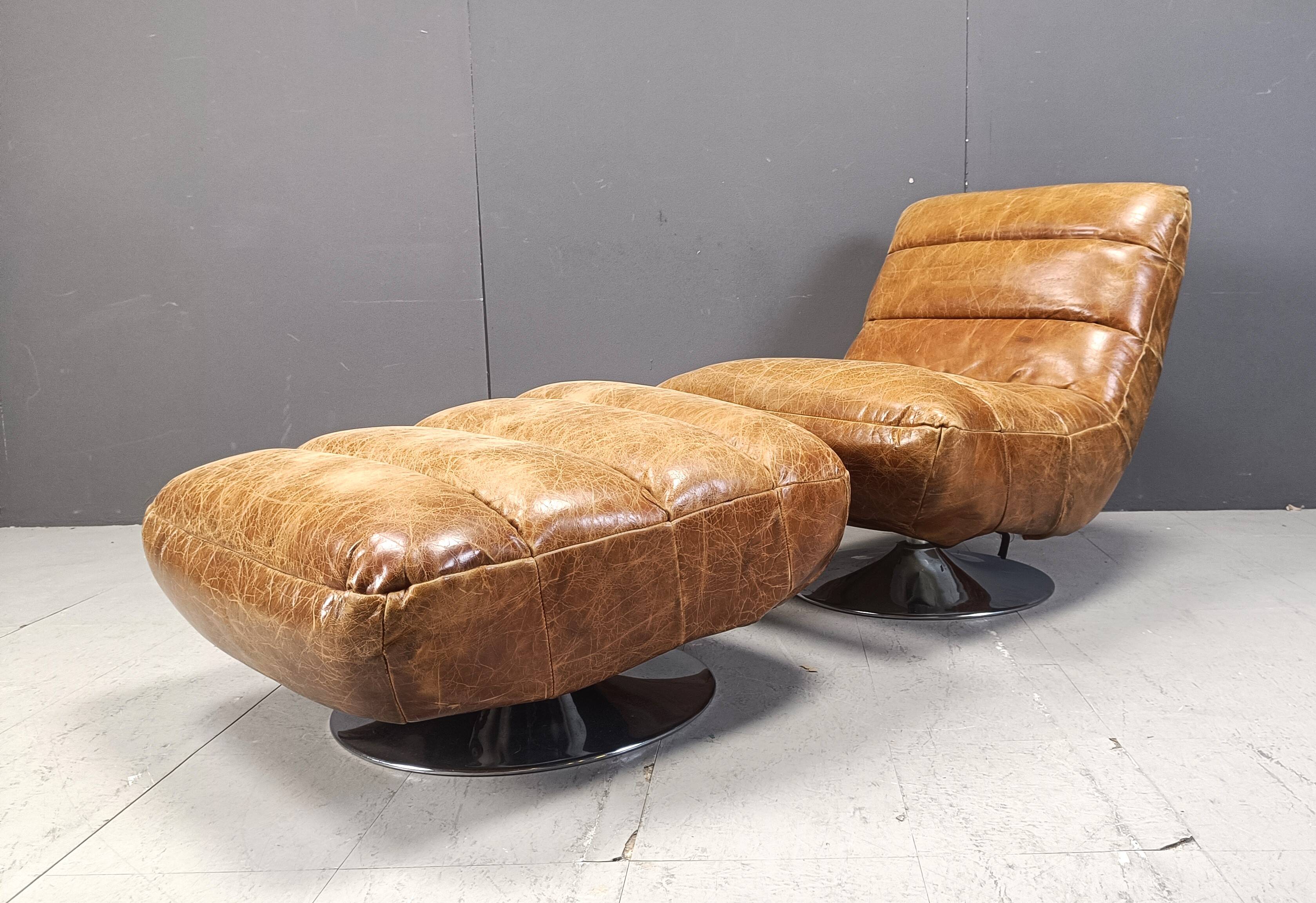 Vintage leather swivel chair with stool, 1970s