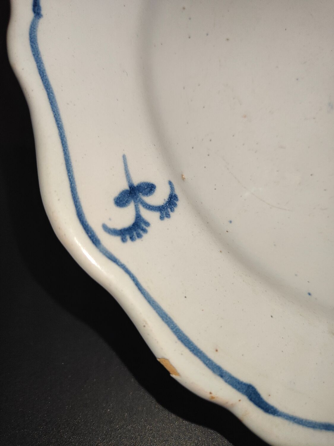 Old plate in Northern earthenware with blue floral decoration eighteenth century