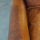 Positively lived-in sheepskin leather wing chair with pleasant seating comfort
